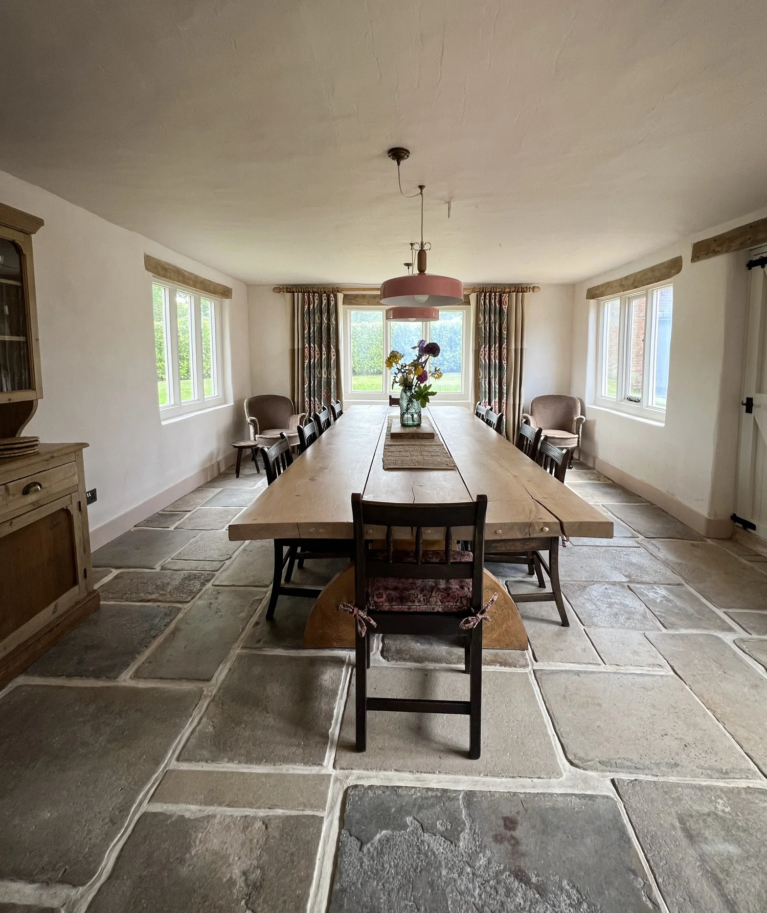 Dining room with oak and yew farmhouse table seating 12