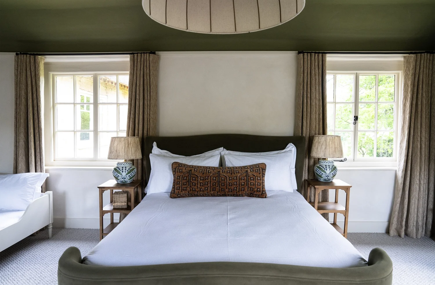 Master bedroom with king-size bed and garden views