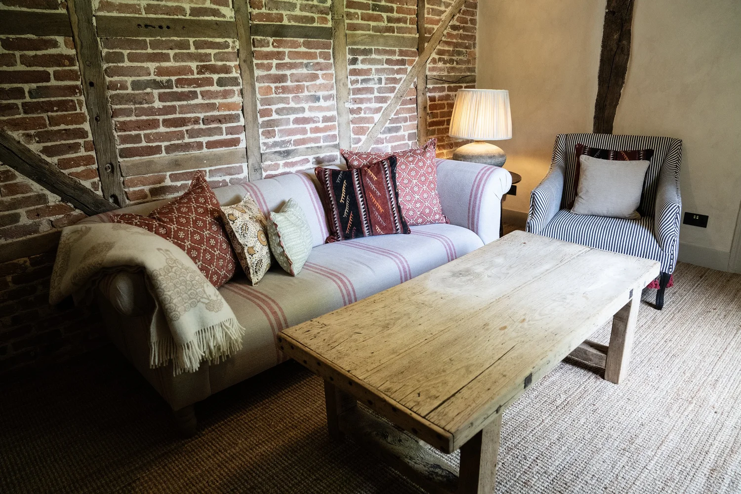 Sitting room with inglenook fireplace and wood-burning stove